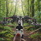 Close-up of a crossbow with a hand holding it, branded 'Wild Slinghotrifle Crossbow'.