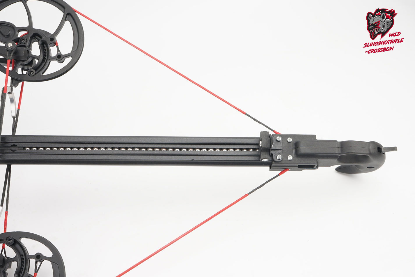 Compound bow with red strings on a white background, featuring Wild Slingbow logo.